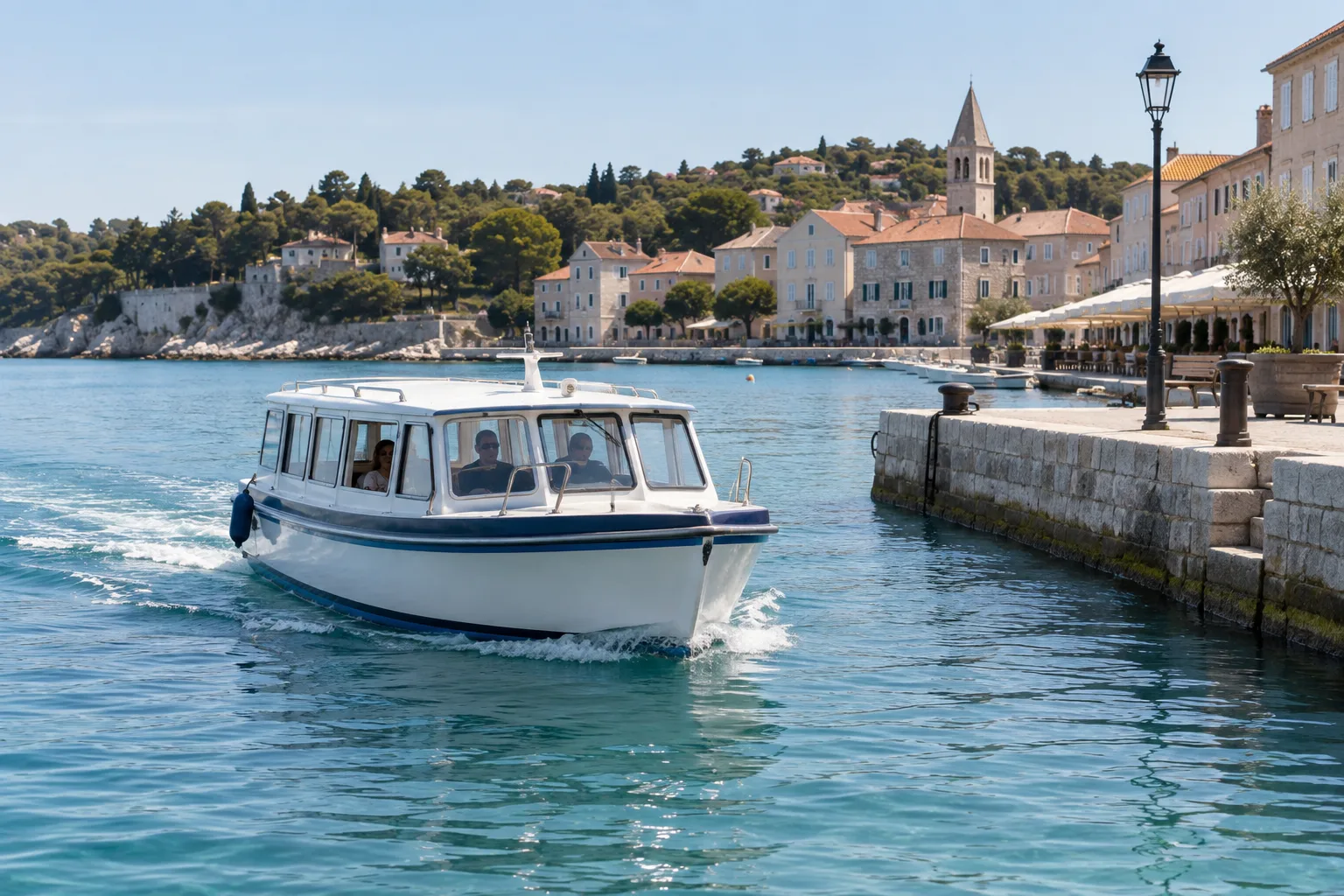 Illustrative small enclosed passenger water taxi beside a town quay