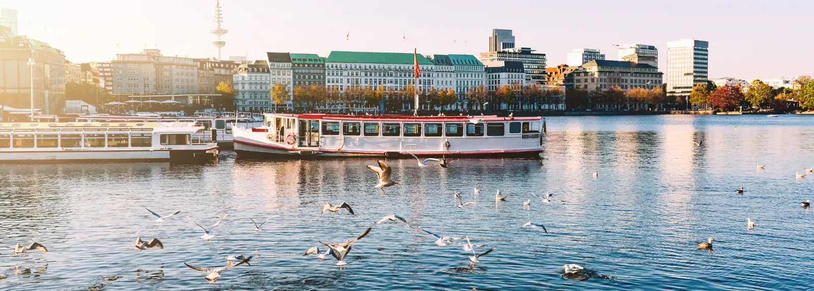 Alster boat by Hamburg's waterfront in evening light.