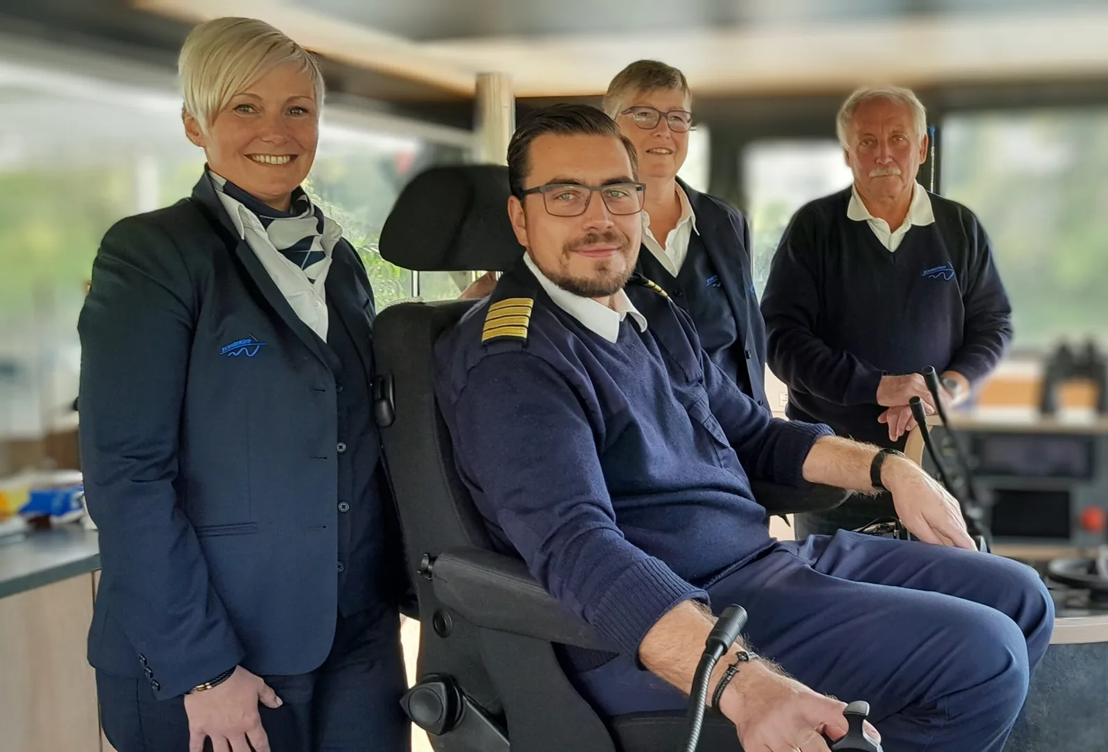 Boat crew in a passenger vessel's wheelhouse.